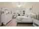 Bright main bedroom with white furniture and wood flooring at 5571 Rock Dove Dr, Sarasota, FL 34241