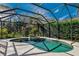 Inviting kidney-shaped pool with screened enclosure at 5571 Rock Dove Dr, Sarasota, FL 34241