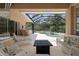 Relaxing screened pool area with patio furniture and fire pit at 5571 Rock Dove Dr, Sarasota, FL 34241