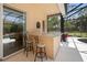 Outdoor wet bar with granite countertop and pool view at 5571 Rock Dove Dr, Sarasota, FL 34241