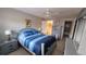 Comfortable bedroom with light blue wood frame bed, side table and closet access at 5880 38Th N Ave # 204, St Petersburg, FL 33710