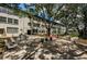 Outdoor patio area with several seating options to enjoy the mature landscaping and community charm at 5880 38Th N Ave # 204, St Petersburg, FL 33710