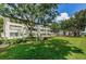 A large grassy lawn, mature trees, and landscaping enhance the curb appeal of this well-kept condominium community at 5880 38Th N Ave # 204, St Petersburg, FL 33710