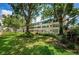 An exterior view shows mature landscaping in front of the building with green lawns and lots of shady spots at 5880 38Th N Ave # 204, St Petersburg, FL 33710
