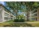A nice exterior view of the apartment buildings reveals mature trees, landscaping, and plenty of shady areas at 5880 38Th N Ave # 204, St Petersburg, FL 33710