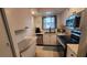 Well-lit kitchen featuring stainless steel appliances, granite countertops, and white cabinets at 5880 38Th N Ave # 204, St Petersburg, FL 33710