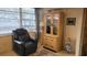 Cozy corner of a living room with ample sunlight, featuring a recliner and glass doored cabinet at 5880 38Th N Ave # 204, St Petersburg, FL 33710