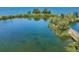 Aerial view of waterfront property with lush landscaping and a boardwalk at 5915 Sea Ranch Dr # 308W, Hudson, FL 34667