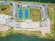 Aerial view of condo complex with tennis courts and waterfront access at 5915 Sea Ranch Dr # 308W, Hudson, FL 34667