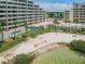 Aerial view of condo complex featuring a private beach area with lounge chairs at 5915 Sea Ranch Dr # 308W, Hudson, FL 34667