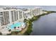 Aerial view of waterfront community with pool and lush landscaping at 5915 Sea Ranch Dr # 308W, Hudson, FL 34667