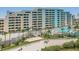 Condo building with pool and private beach access, as seen from above at 5915 Sea Ranch Dr # 308W, Hudson, FL 34667