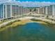 Aerial view of condo complex with private beach access and lush landscaping at 5915 Sea Ranch Dr # 308W, Hudson, FL 34667