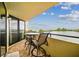 Spacious balcony with table and chairs, offering stunning water views at 5915 Sea Ranch Dr # 308W, Hudson, FL 34667