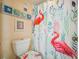 Bathroom with flamingo shower curtain and seashell decor at 5915 Sea Ranch Dr # 308W, Hudson, FL 34667