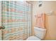 Clean bathroom with flamingo shower curtain and toilet at 5915 Sea Ranch Dr # 308W, Hudson, FL 34667