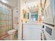 Bathroom with toilet, shower, vanity, and laundry at 5915 Sea Ranch Dr # 308W, Hudson, FL 34667