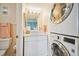 Bright bathroom with white vanity and stackable washer/dryer at 5915 Sea Ranch Dr # 308W, Hudson, FL 34667