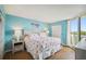 King-size bed, flamingo decor, and access to balcony in this bedroom at 5915 Sea Ranch Dr # 308W, Hudson, FL 34667