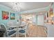 Bright dining area with glass table and seating for four, adjacent to kitchen at 5915 Sea Ranch Dr # 308W, Hudson, FL 34667