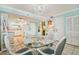 Dining area with glass top table and white wicker chairs at 5915 Sea Ranch Dr # 308W, Hudson, FL 34667