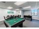 Game room with pool table, foosball, and clock on the wall at 5915 Sea Ranch Dr # 308W, Hudson, FL 34667