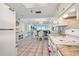 Kitchen with granite counters, white appliances, and view to dining area at 5915 Sea Ranch Dr # 308W, Hudson, FL 34667