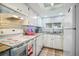 Updated condo kitchen with white cabinets and granite countertops at 5915 Sea Ranch Dr # 308W, Hudson, FL 34667