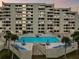 Community pool with lounge chairs and surrounding building at 5915 Sea Ranch Dr # 308W, Hudson, FL 34667