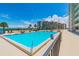 Inviting community pool with lounge chairs and stunning water views at 5915 Sea Ranch Dr # 308W, Hudson, FL 34667