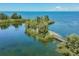 Stunning waterfront view with a wooden bridge and lush foliage at 5915 Sea Ranch Dr # 308W, Hudson, FL 34667