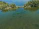Calm waterfront view with a wooden boardwalk at 5915 Sea Ranch Dr # 308W, Hudson, FL 34667