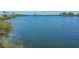Tranquil waterfront view with calm water and lush vegetation at 5915 Sea Ranch Dr # 308W, Hudson, FL 34667