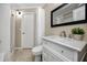 Updated bathroom with white vanity and tiled shower at 6923 Dartmouth N Ave, St Petersburg, FL 33710