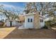 House exterior featuring gray siding, black shutters and stone accents at 6923 Dartmouth N Ave, St Petersburg, FL 33710
