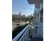 Balcony view overlooking a tree-lined street and city buildings at 700 Beach Ne Dr # 401, St Petersburg, FL 33701