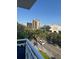 Balcony view of a tree-lined street with city buildings in the distance at 700 Beach Ne Dr # 401, St Petersburg, FL 33701