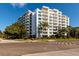 Harbour Hill's exterior, a multi-story building with balconies and palm trees at 700 Beach Ne Dr # 401, St Petersburg, FL 33701