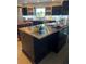 Modern kitchen with a stainless steel island and dark wood cabinetry at 700 Beach Ne Dr # 401, St Petersburg, FL 33701