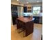 Live edge wood kitchen island with metal stools at 700 Beach Ne Dr # 401, St Petersburg, FL 33701