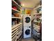 Laundry room with stacked washer and dryer, plus shelving at 700 Beach Ne Dr # 401, St Petersburg, FL 33701