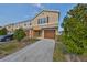 Two-story townhome with attached garage and small front yard at 7134 Merlot Sienna Ave, Gibsonton, FL 33534