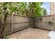 Enclosed backyard area with wooden fence, foliage, and string lights for ambiance at 8013 Peach Dr, Temple Terrace, FL 33637