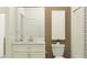 Clean bathroom with white vanity, brown accent wall, and a tiled shower at 9760 Minnow Ray Dr, Land O Lakes, FL 34638