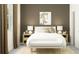 Bright bedroom with a cozy bed, wood nightstands, and neutral decor at 9760 Minnow Ray Dr, Land O Lakes, FL 34638