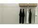 White closet with wire shelving and hanging clothes at 9760 Minnow Ray Dr, Land O Lakes, FL 34638