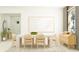 Modern dining room with a white table, light beige chairs, and a light wood sideboard at 9760 Minnow Ray Dr, Land O Lakes, FL 34638