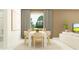 Elegant dining room features a white table and six chairs, plus access to living room at 9760 Minnow Ray Dr, Land O Lakes, FL 34638
