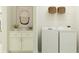 Bright laundry room with washer, dryer, and cabinets at 9760 Minnow Ray Dr, Land O Lakes, FL 34638