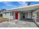 Newly renovated home with a carport and red front door at 10515 118Th Ave, Largo, FL 33773